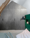 Ambiance chambre avec portes de placard décorées avec le Badigeon teinte Aluminium, murs blancs et tête de lit verte 