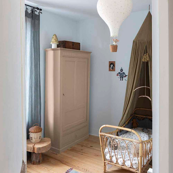 Ambiance d'une chambre d'enfant aux murs bleu, avec armoire rose, peinture Meuble Signé Mat à base de Caséine teinte Rose Poudré Libéron