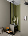 Coin chambre et salle d’eau aux murs vert botanique et gris grande dame Libéron, avec verrière noire et chaise bois.
