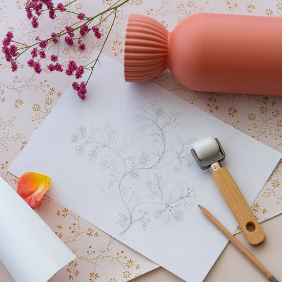 Détail de papier peint floral Belle Jeanne Libéron, avec vase corail, fleurs roses, dessin botanique et petit rouleau.