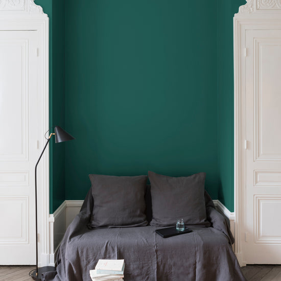 Salon aux murs verts, peinture Velours de Peinture Feuille d'Acanthe Libéron avec portes blanches et textiles gris.
