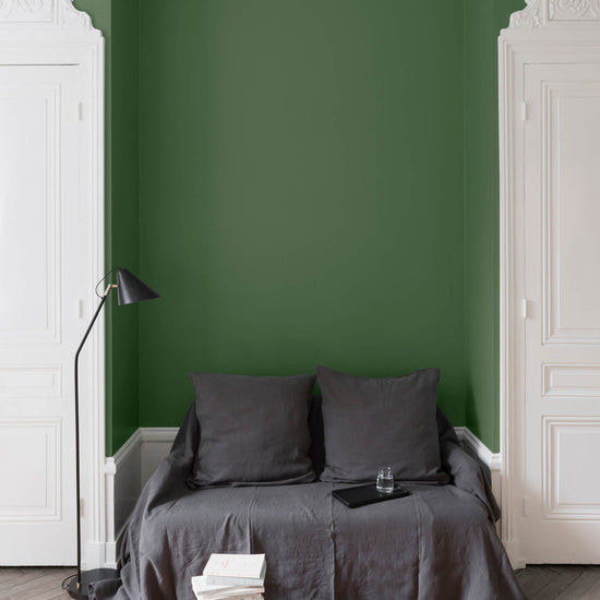 Salon aux murs Vert Potager, Velours de Peinture Libéron, avec canapé gris, portes blanches et parquet clair.