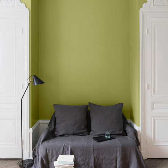 Salon aux murs verts, peinture Velours de Peinture Vert Reine-Claude Libéron avec portes blanches et textiles gris.